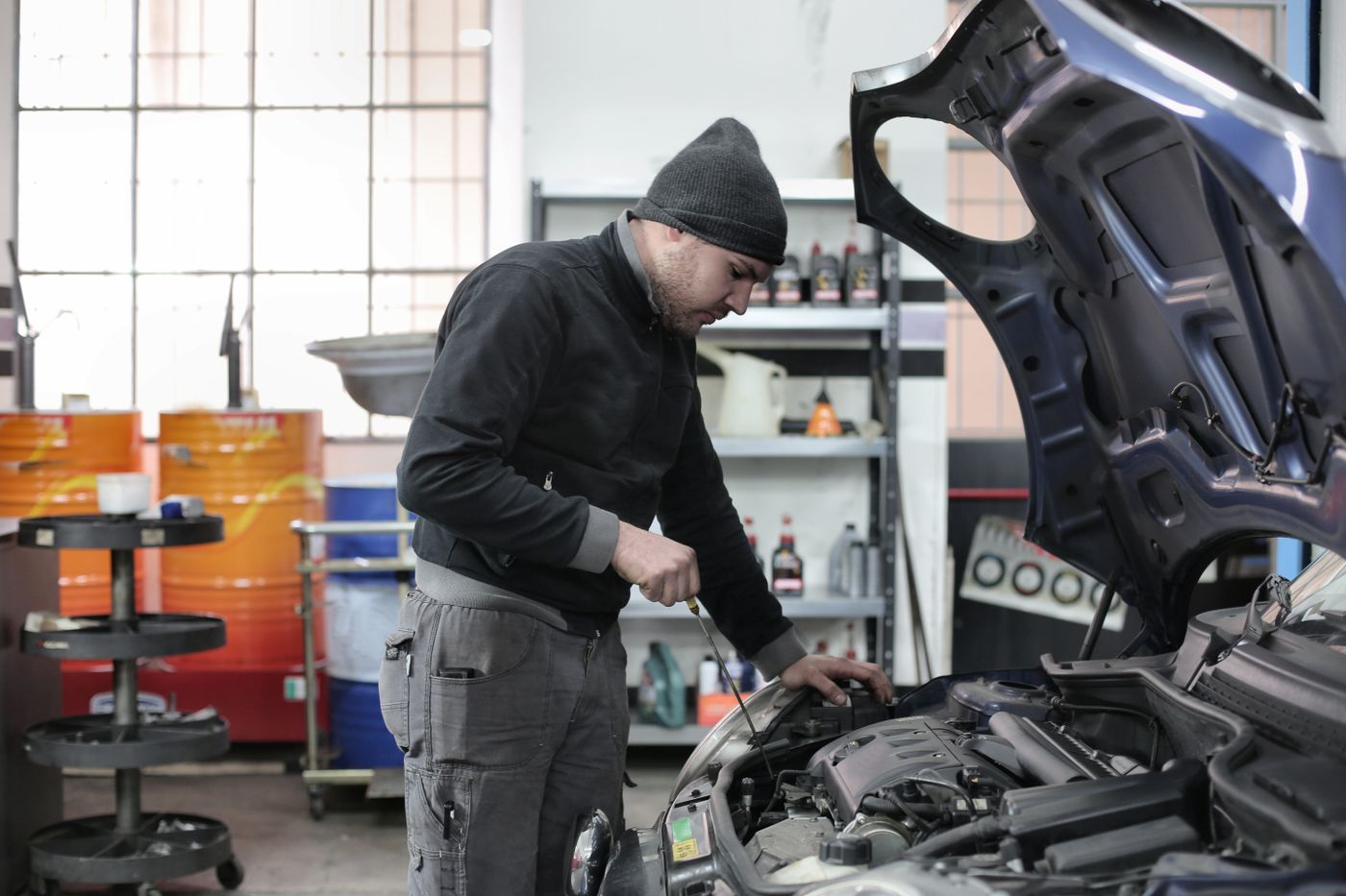 Technician running computer diagnostics on an engine