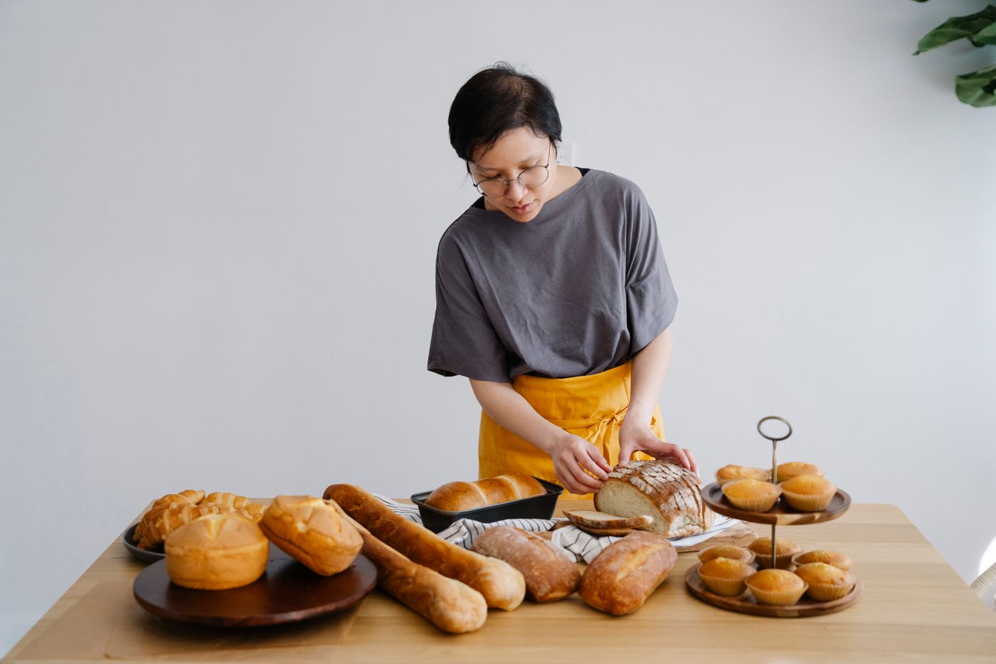 Baker slicing fresh bread by hand