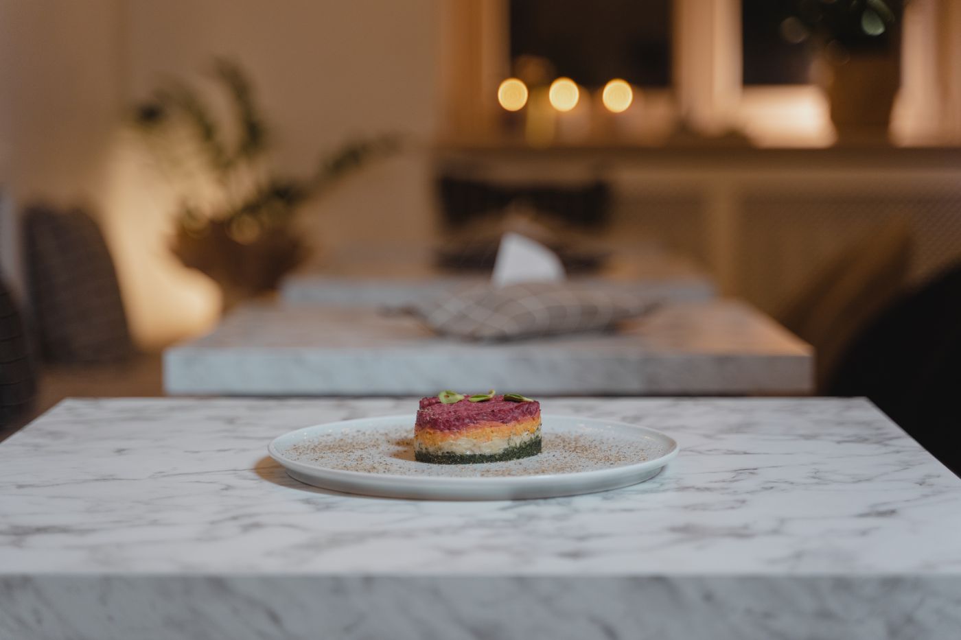 Signature dish plated on marble under warm light