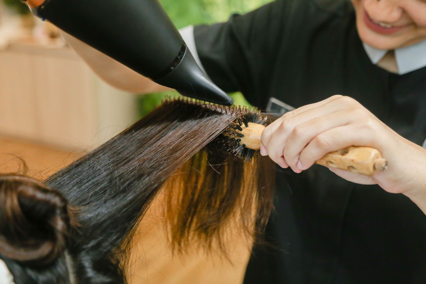 Stylist finishing a soft glam blowout
