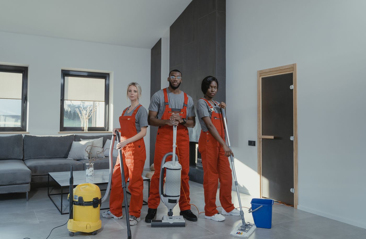 Cleaning team working through a living room