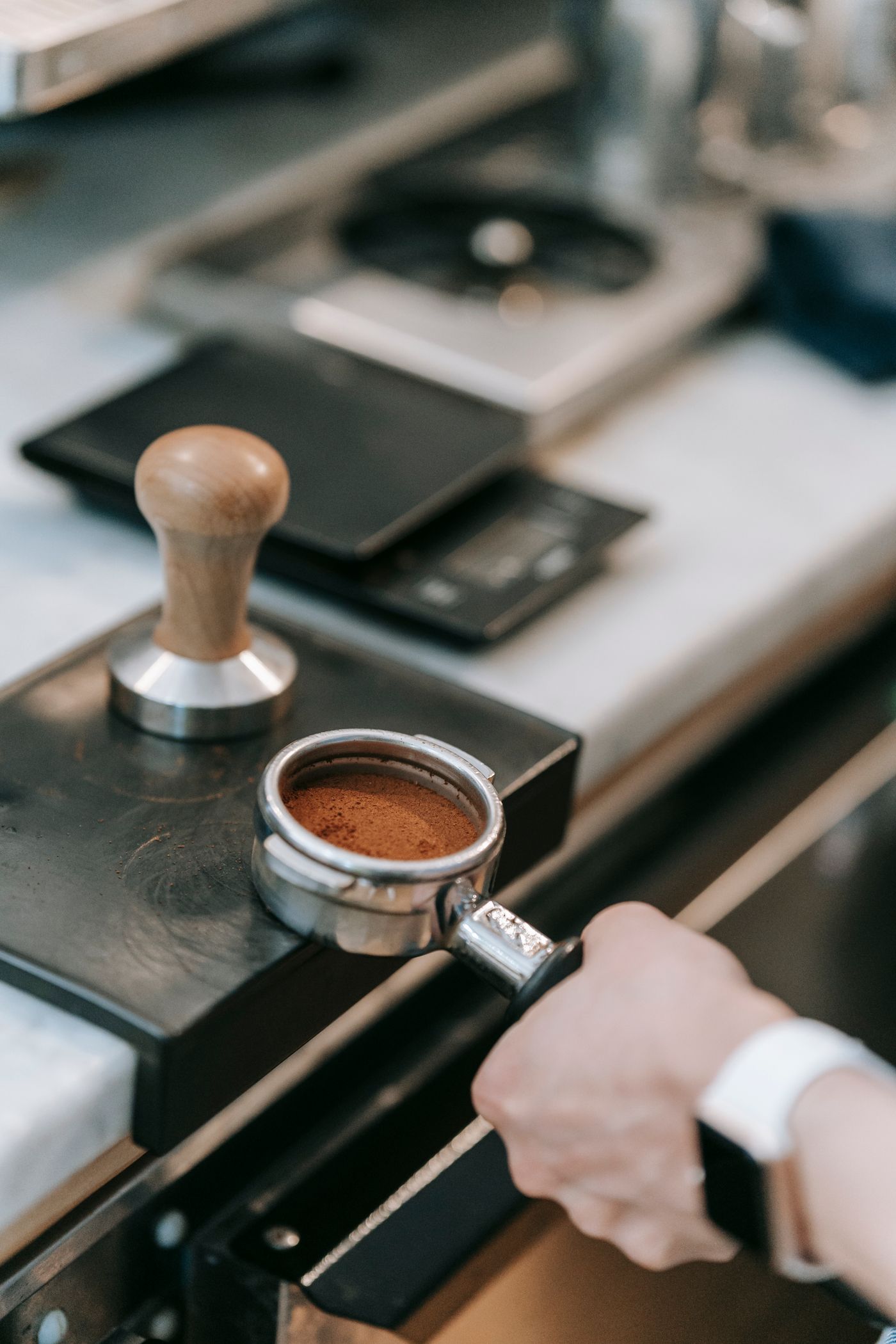 Barista pulling espresso through a portafilter