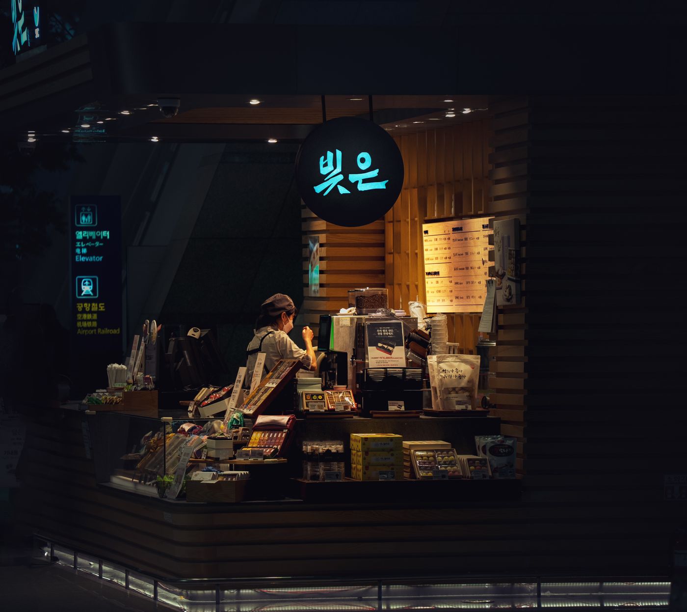 The café glowing at night through the window