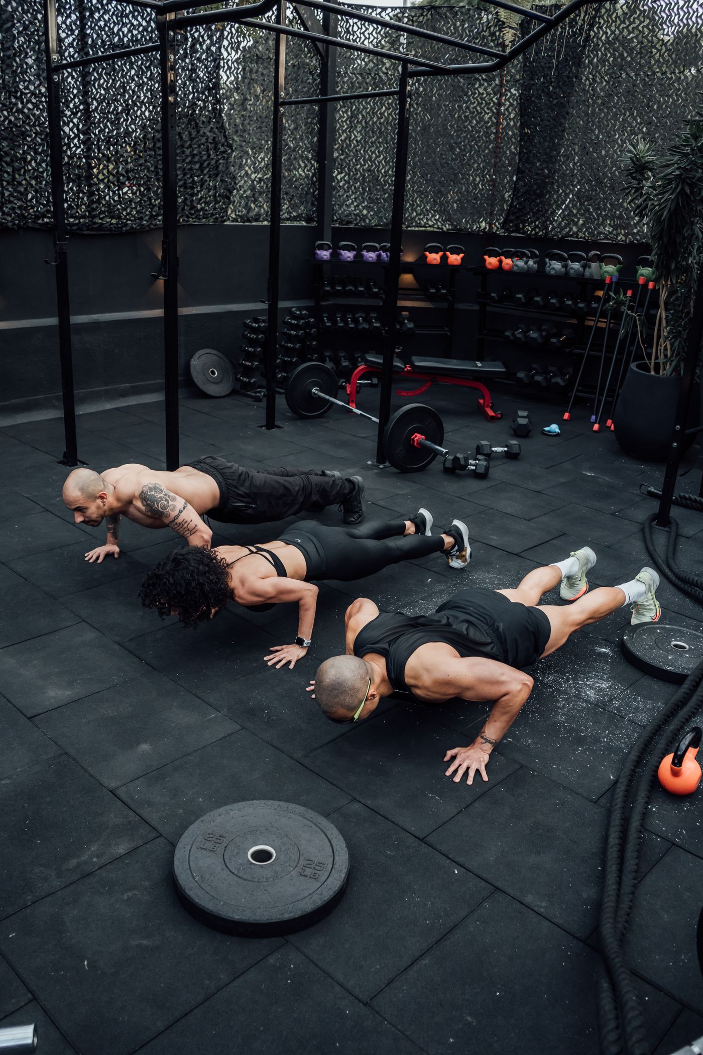 Group class mid-workout with coach guiding form