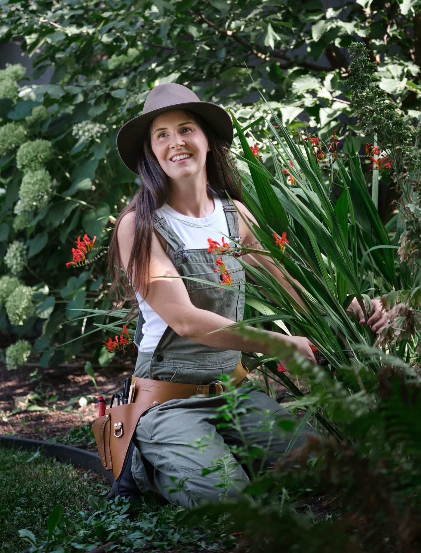 Gardener among vibrant summer flowers