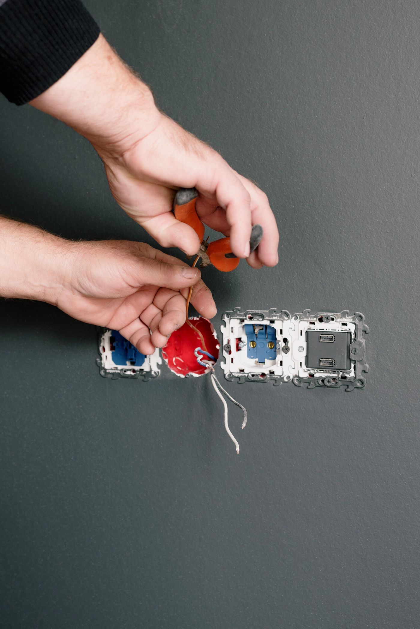 Electrician installing a modern light fixture