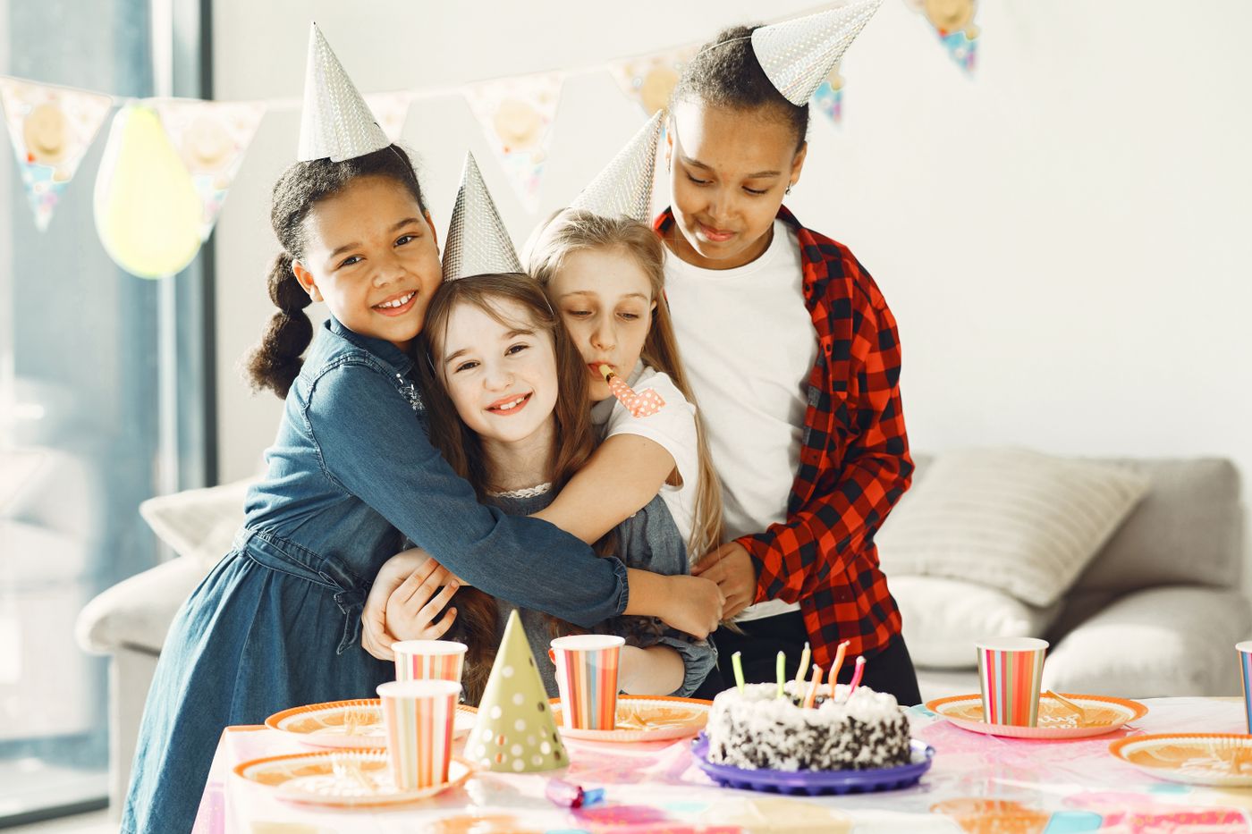 Kids celebrating with hats and cake