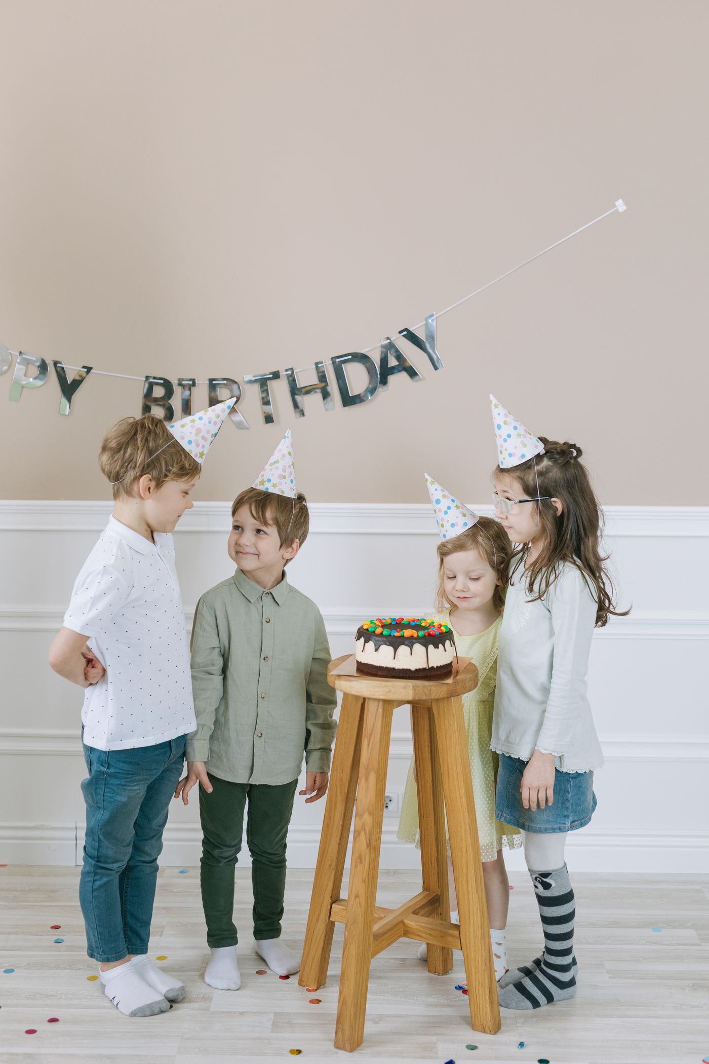 Kids celebrating with cake and hats