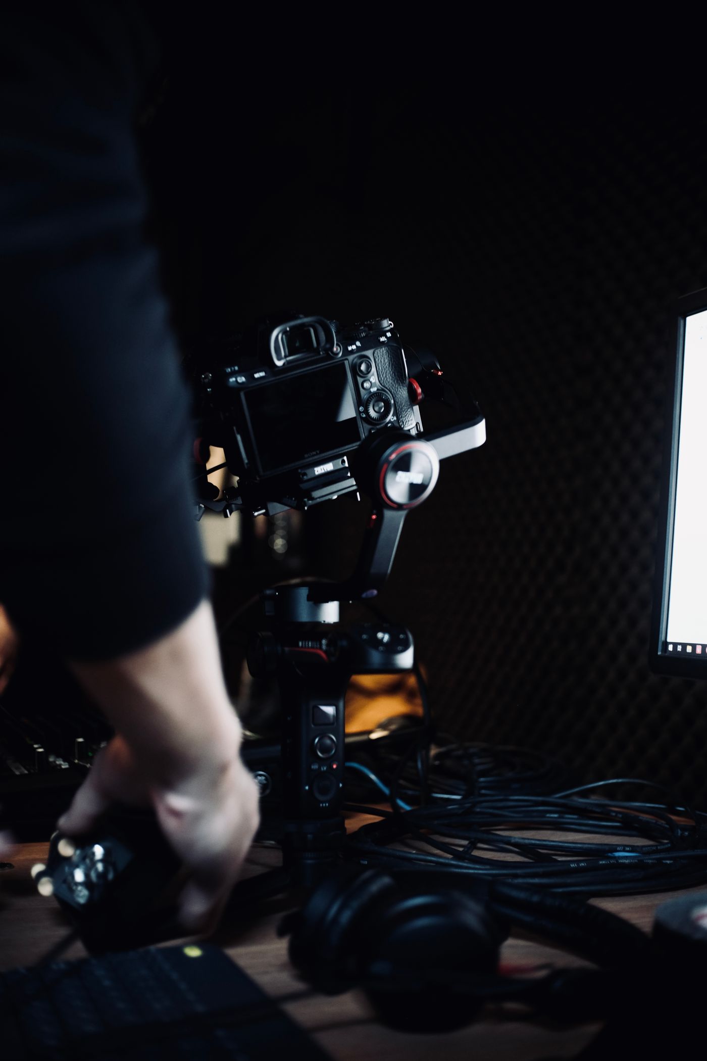 Cinema camera on a tripod in a dark studio