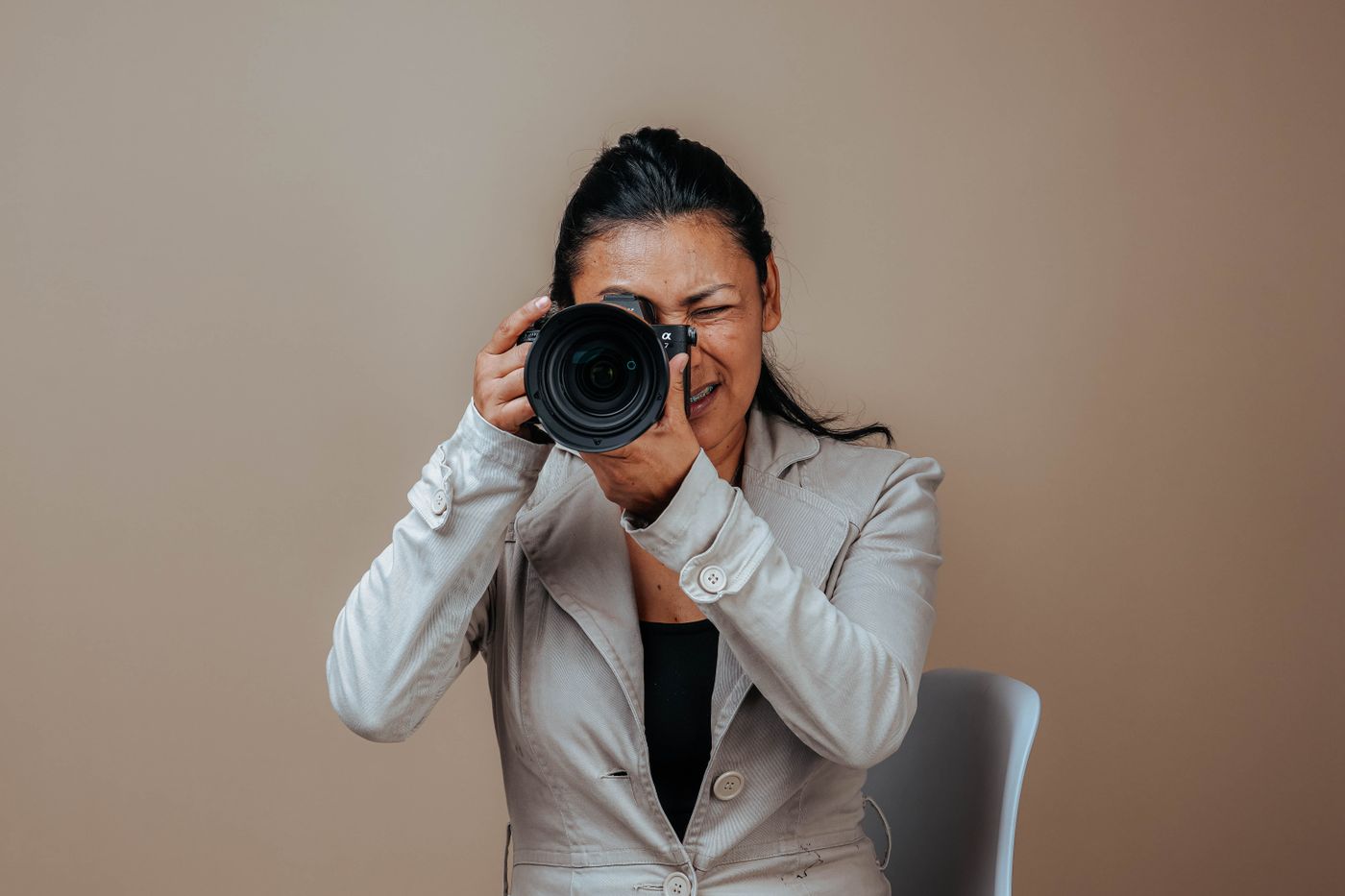 Photographer aiming her camera in the studio