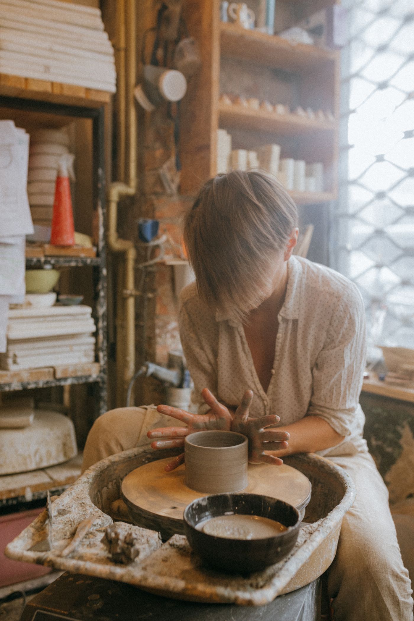 Potter at the wheel in the workshop
