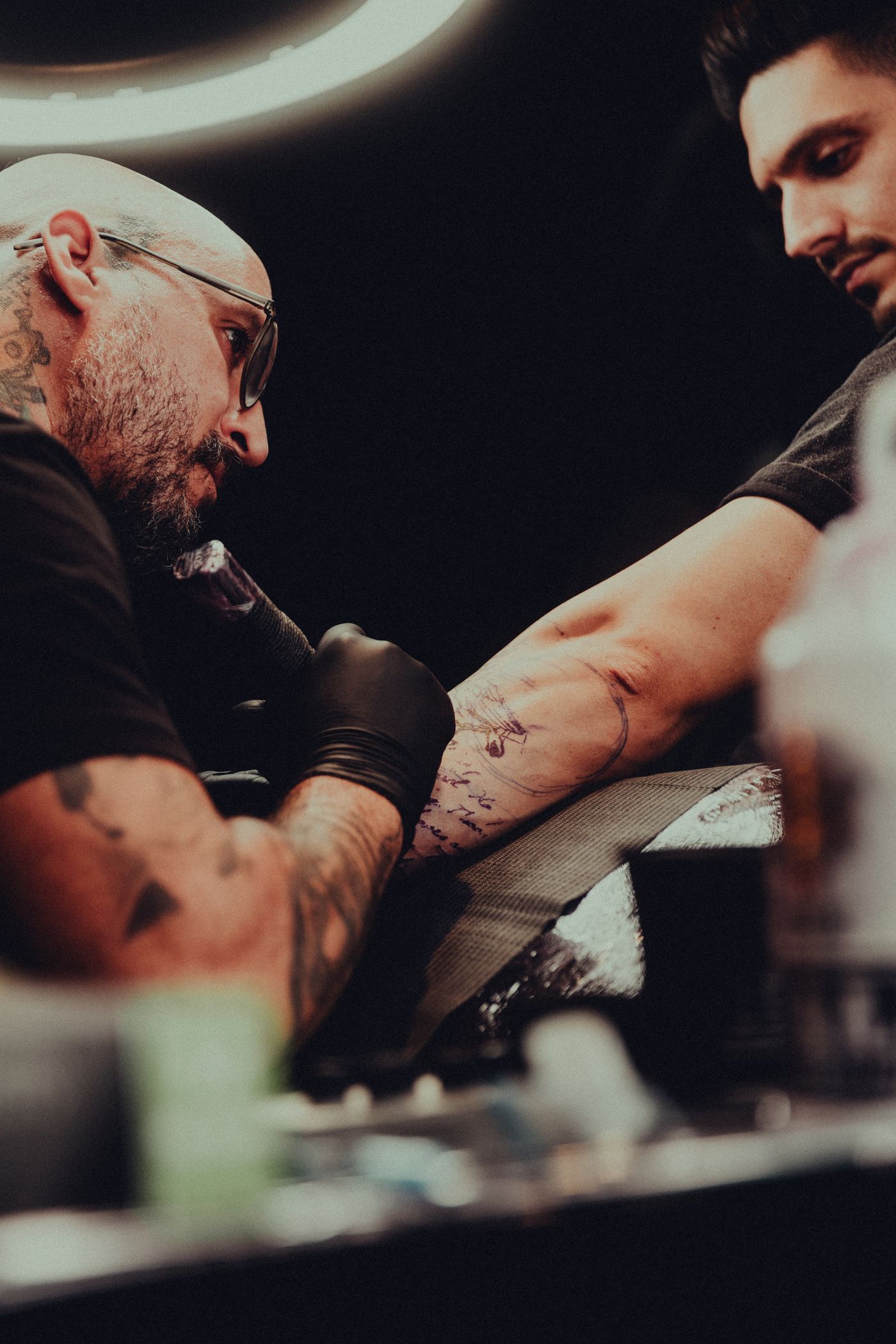 Close-up of a tattoo in progress with gloved hands