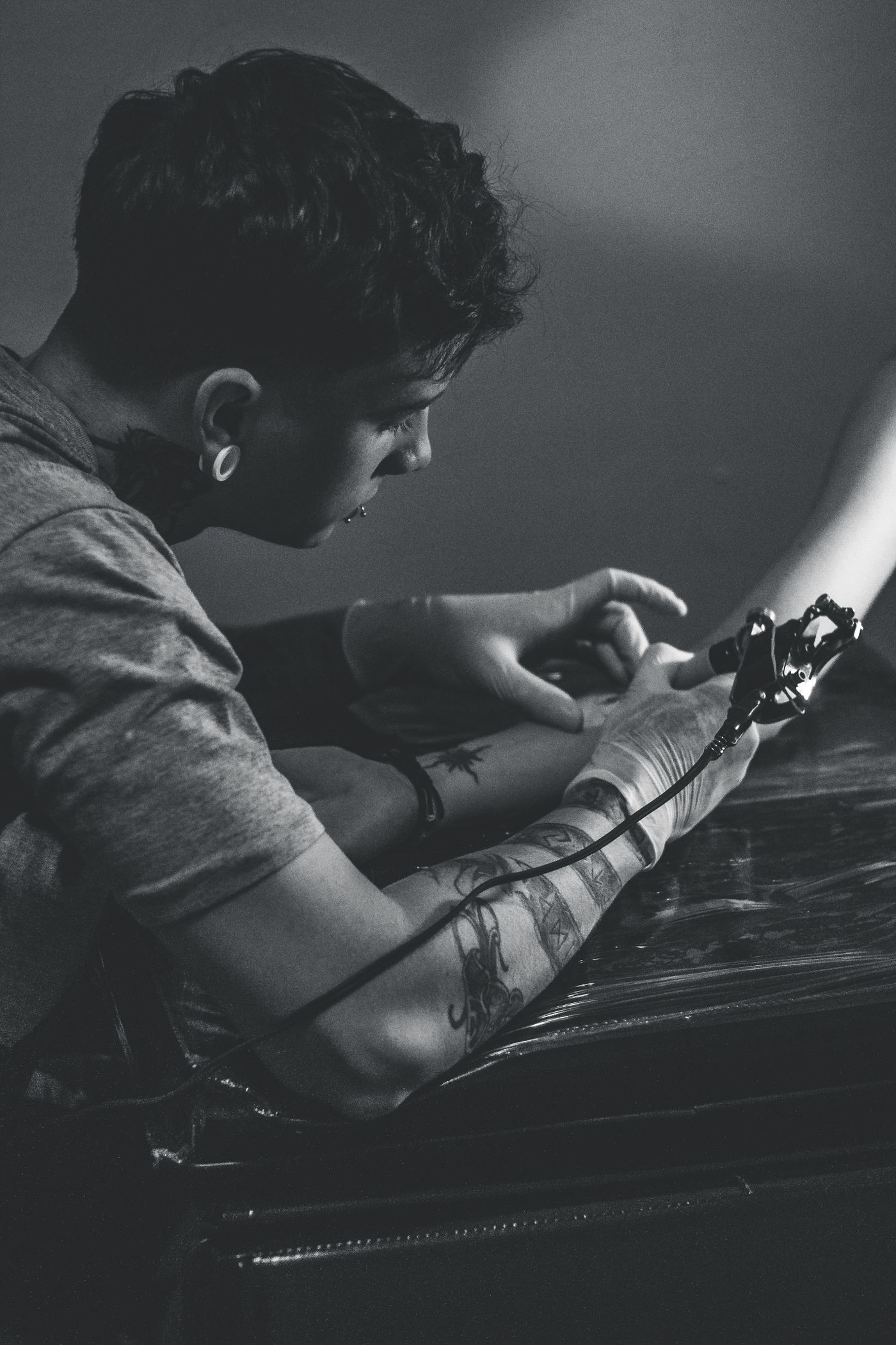 Tattoo artist working on a detailed sleeve