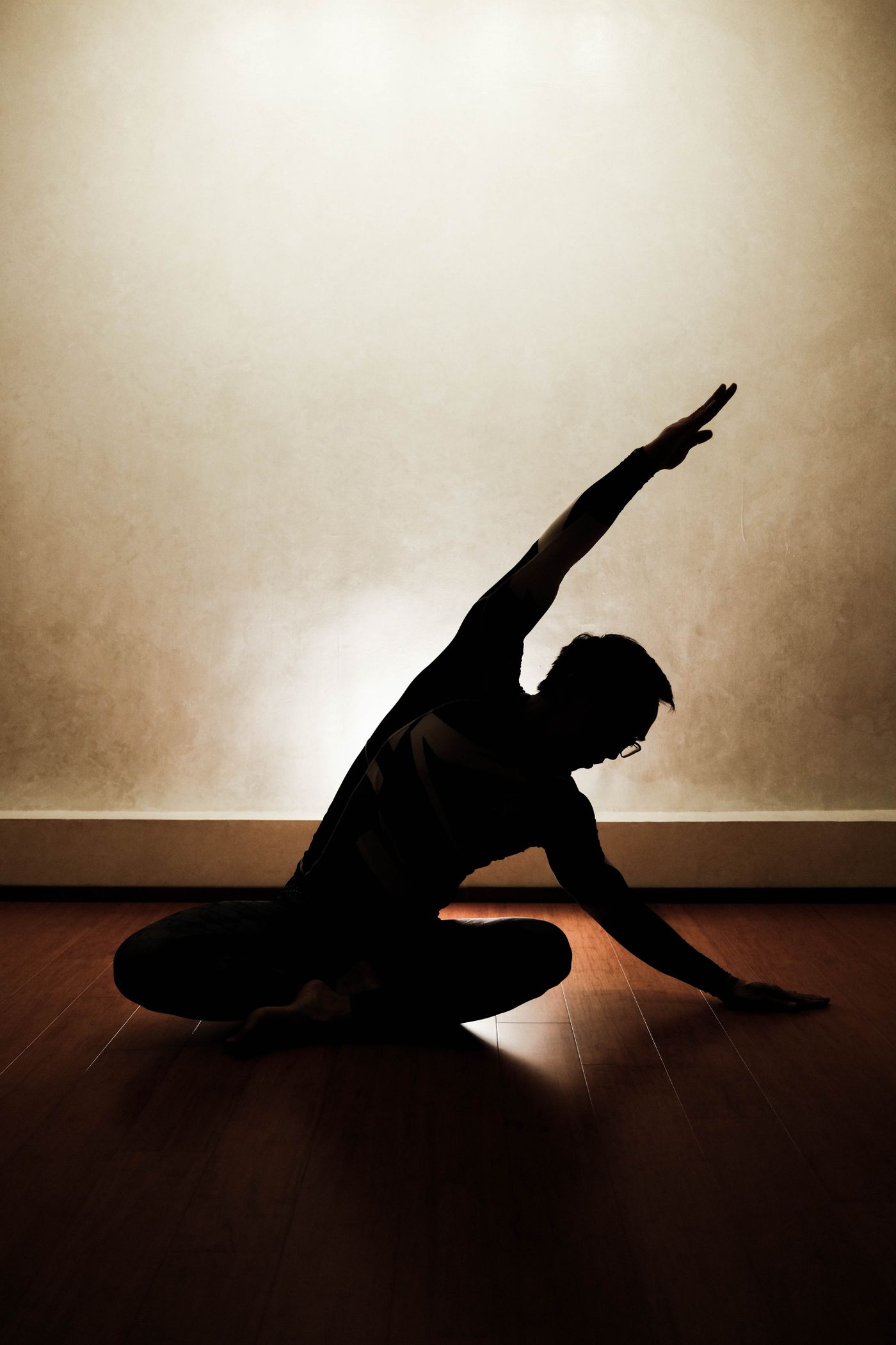 Silhouetted yoga pose at dusk